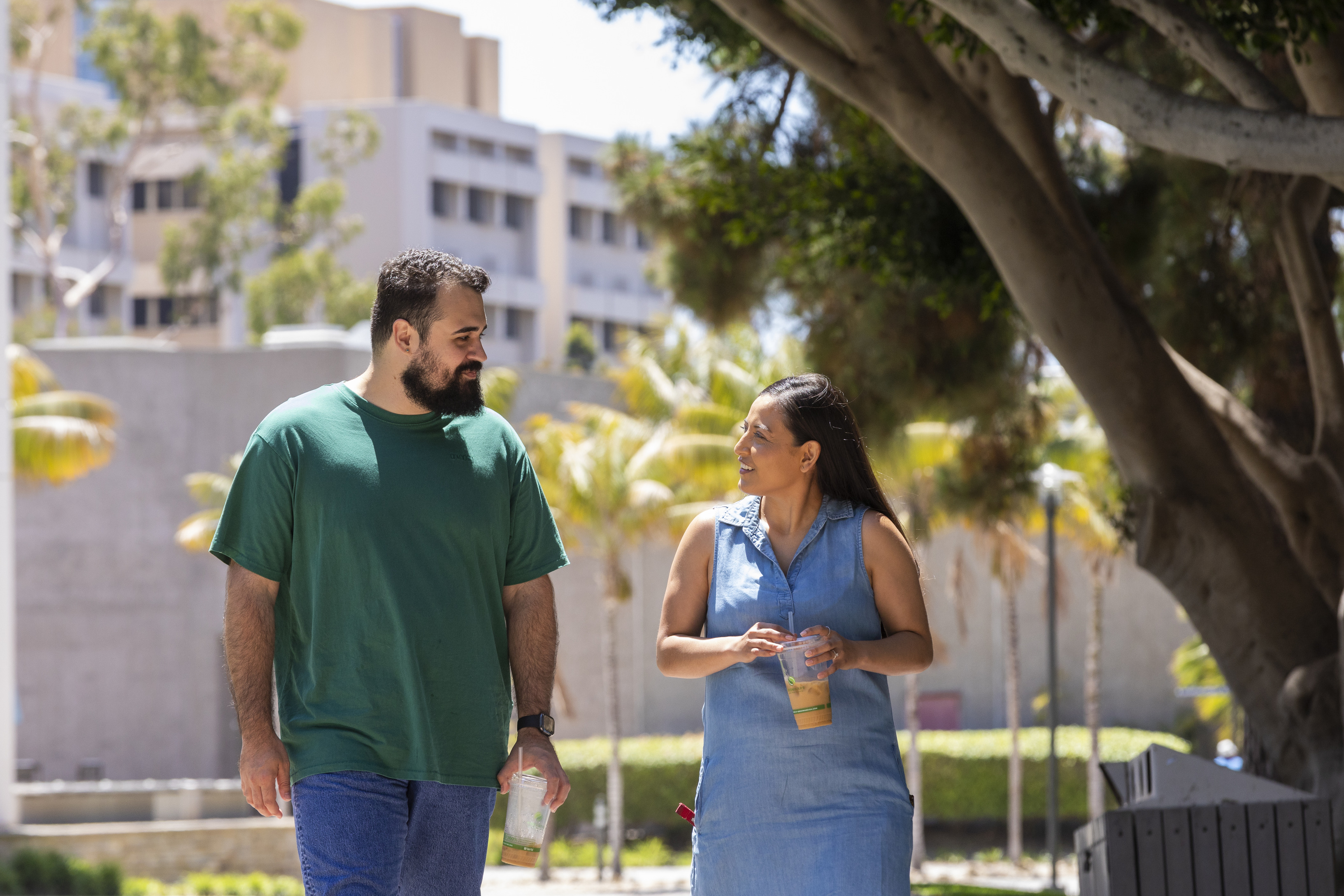 Two people discussing while walking through campus